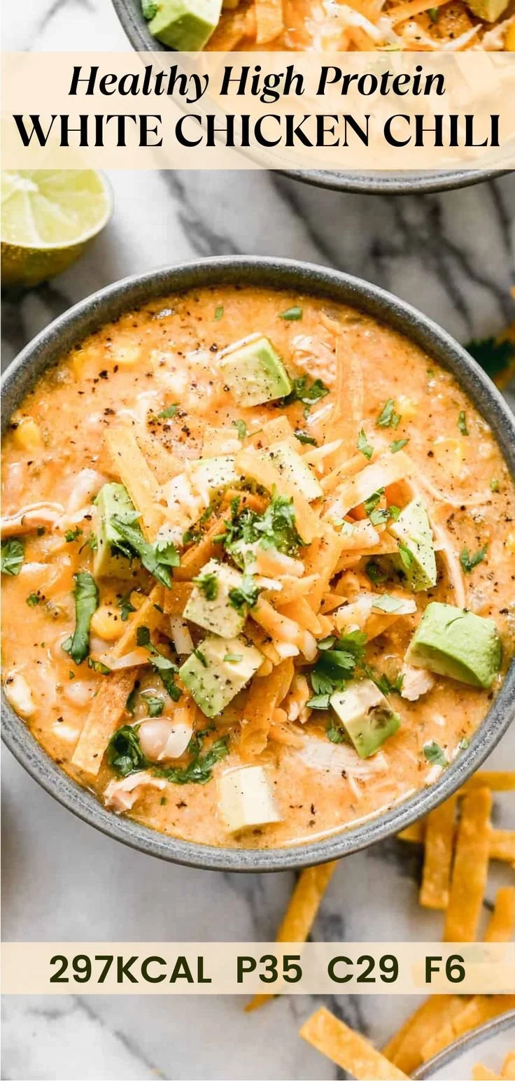 Bowl of high protein white chicken chili topped with cilantro and cheese.