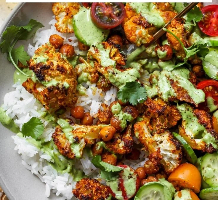Healthy cauliflower shawarma bowls with fresh vegetables and spices