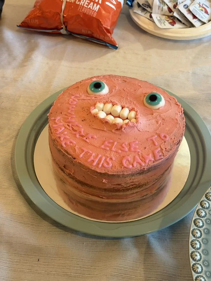 A spooky cursed cake with dark icing and eerie decorations