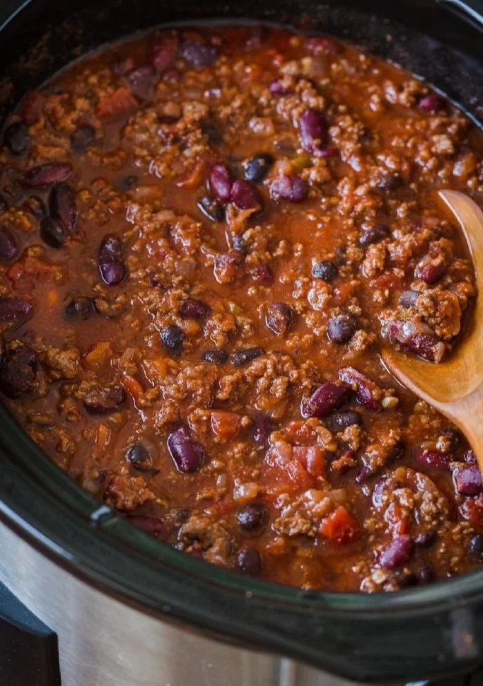 Delicious bowl of easy slow cooker chili topped with cilantro and cheese