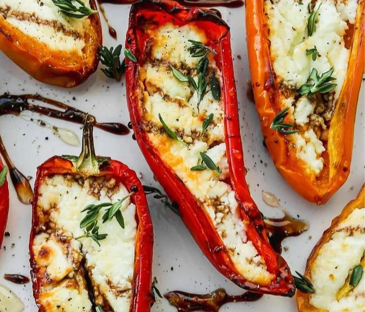 Goat cheese stuffed mini peppers appetizer with honey drizzle