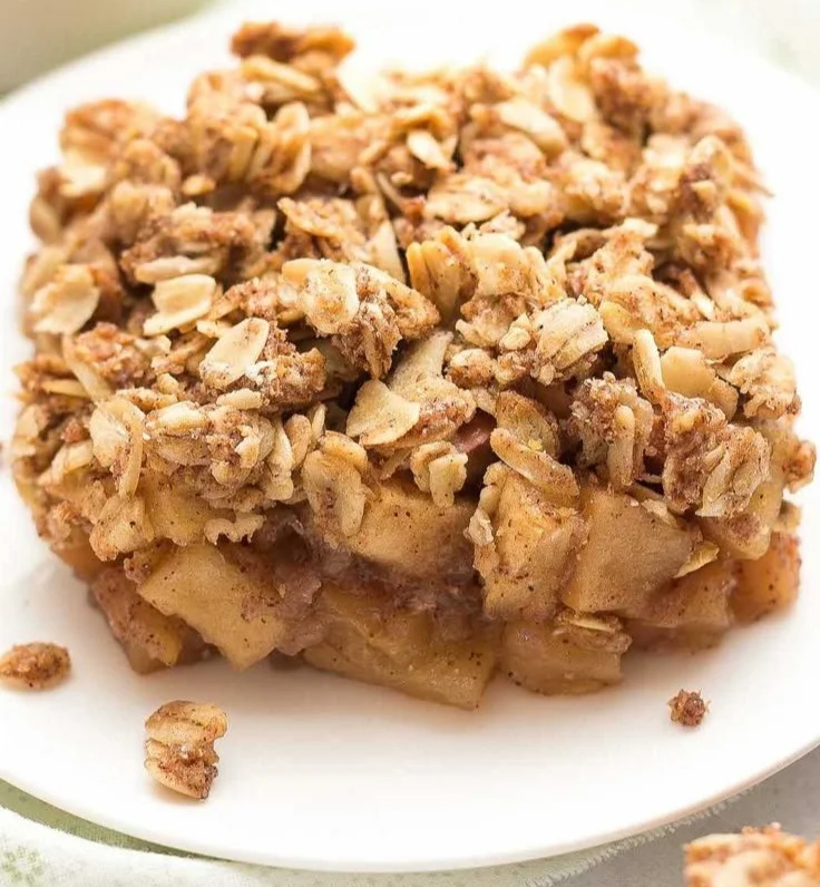 Healthy Chai Spice Apple Crumble topped with oats and spices in a baking dish