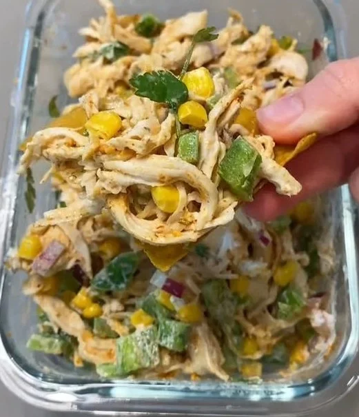 Bowl of Mexican-inspired chicken salad with fresh vegetables and herbs