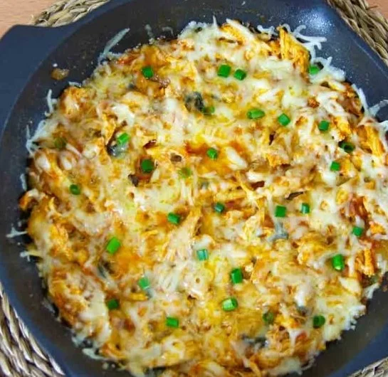 One Pot Chicken Enchilada Skillet with melted cheese and vibrant toppings