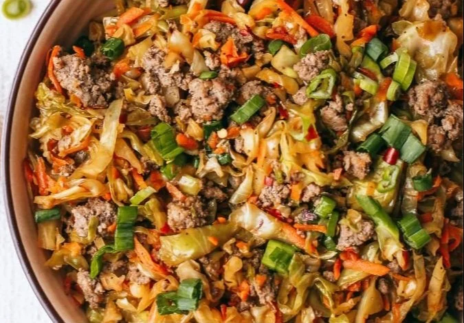 Paleo egg roll in a bowl recipe with fresh vegetables and seasonings