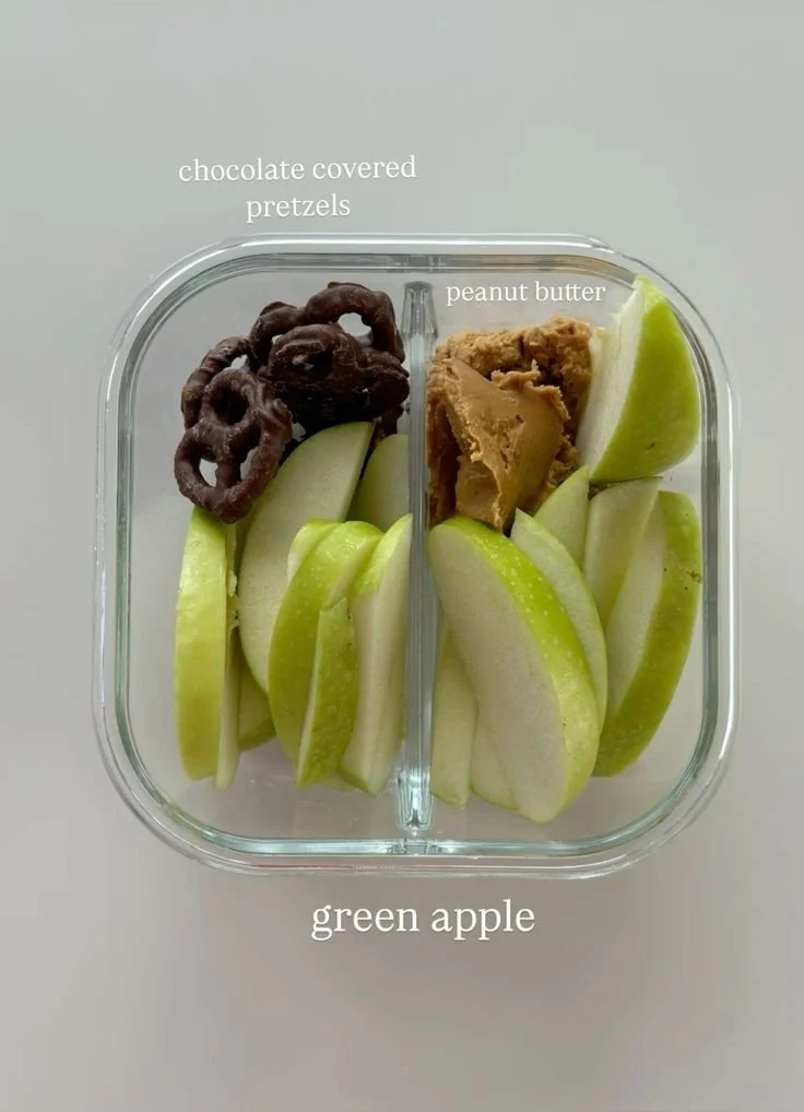 Delicious protein snack box filled with healthy treats like nuts, apples, and pretzels.