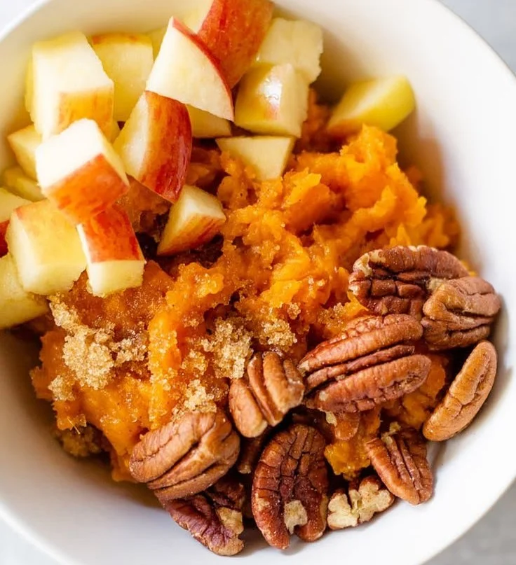 Sweet potato breakfast bowl topped with avocado and eggs