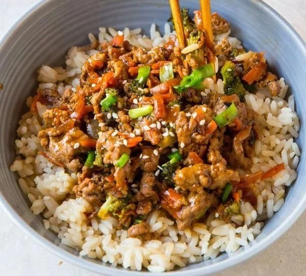 Teriyaki Turkey Rice Bowl garnished with fresh vegetables and sesame seeds
