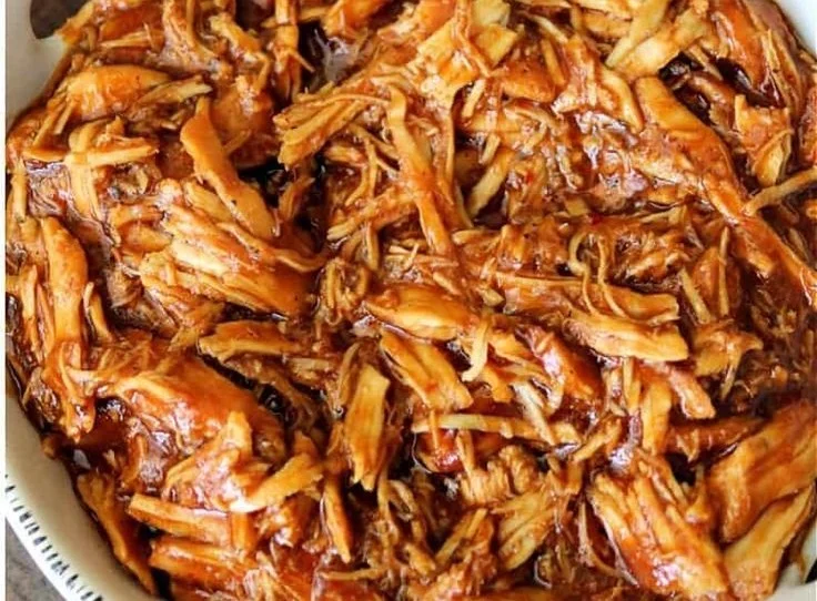 Crockpot BBQ chicken served on a plate, showcasing juicy pulled chicken