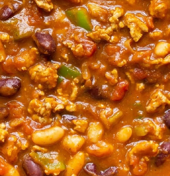 Delicious bowl of turkey pumpkin chili topped with fresh herbs