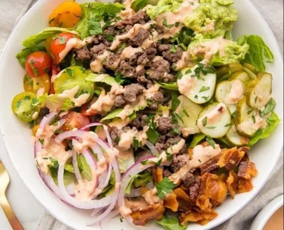 Colorful Whole 30 Burger Bowl with fresh vegetables and lean protein.
