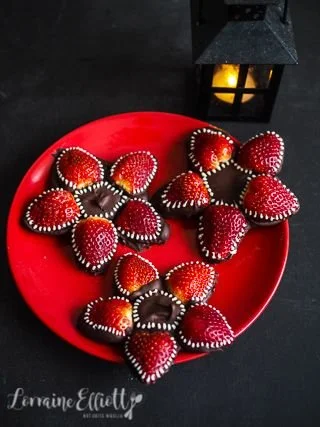 A vibrant bowl of Demogorgon Strawberries showcasing their unique shape and color.