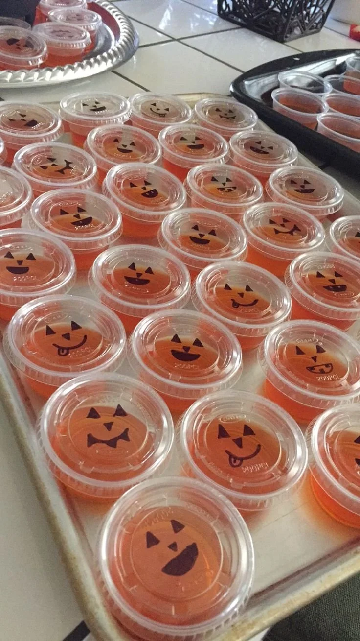 Fireball jello shots made with apple cider in jack-o-lantern shapes
