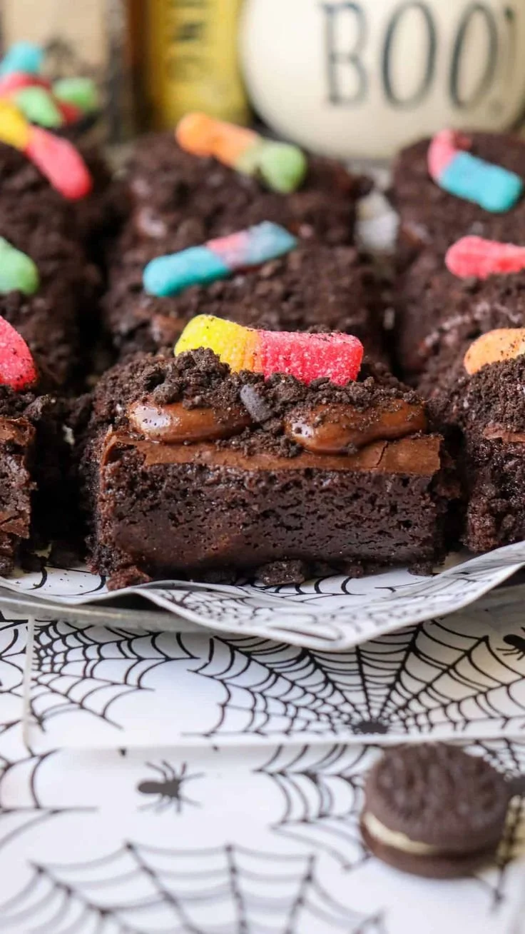 Halloween brownies topped with chocolate fudge, Oreos, and gummy worms