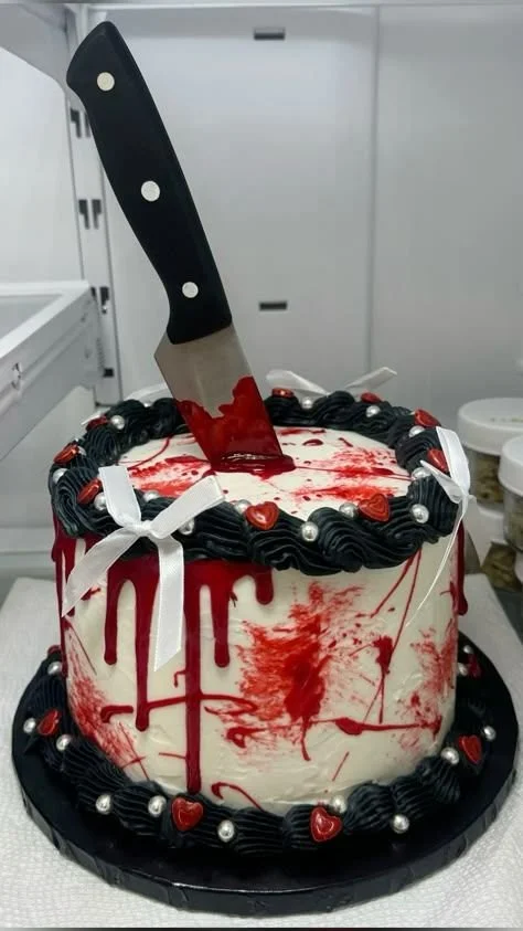 Gothic birthday cake with horror theme design and Halloween decorations.