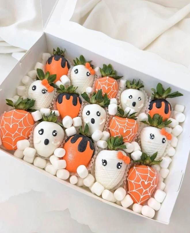 Halloween chocolate covered strawberries decorated for spooky celebrations.