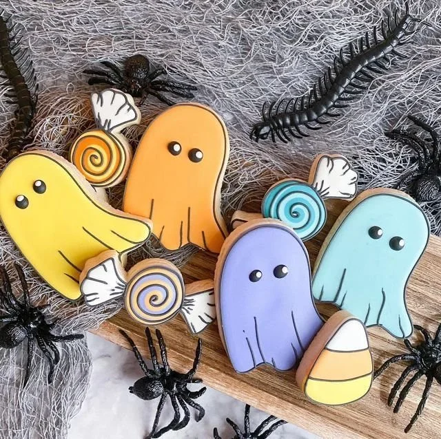 Festively decorated Halloween cookies on a stick by Posh Piper Cookies.