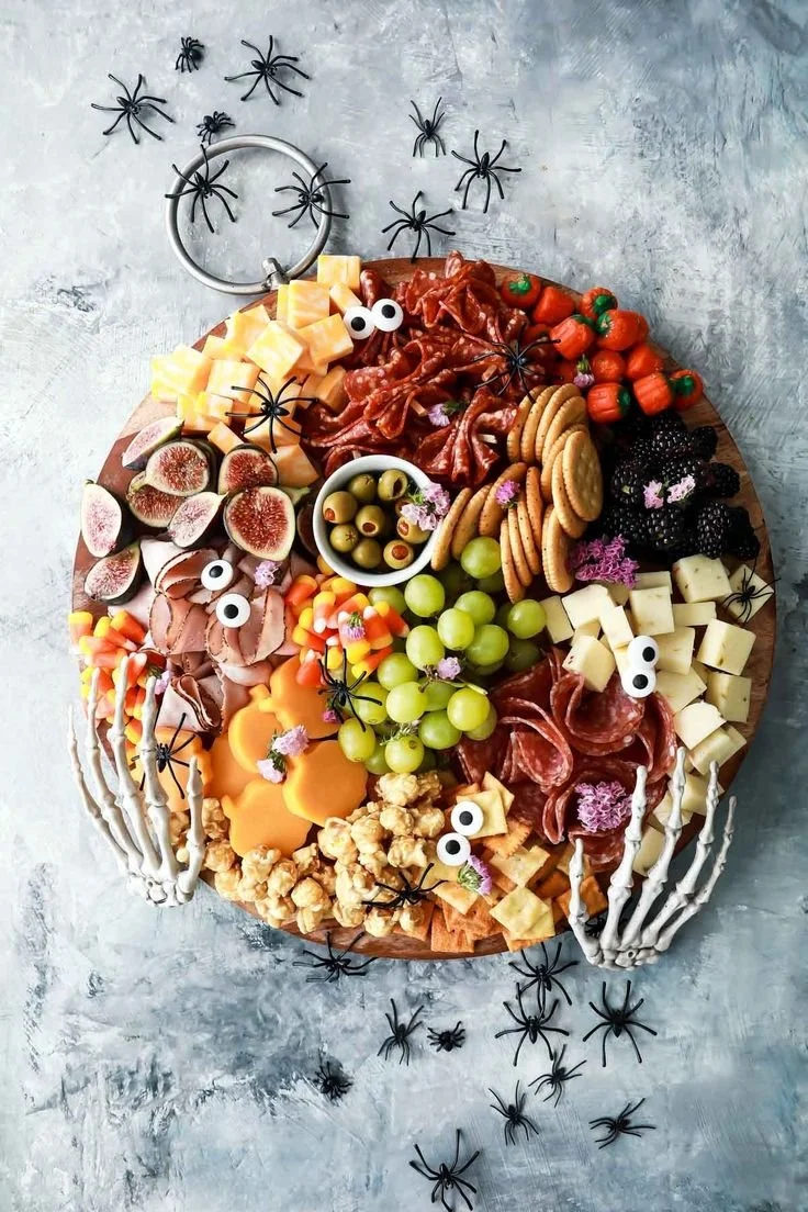 Colorful Halloween charcuterie board decorated with spooky snacks and festive treats.