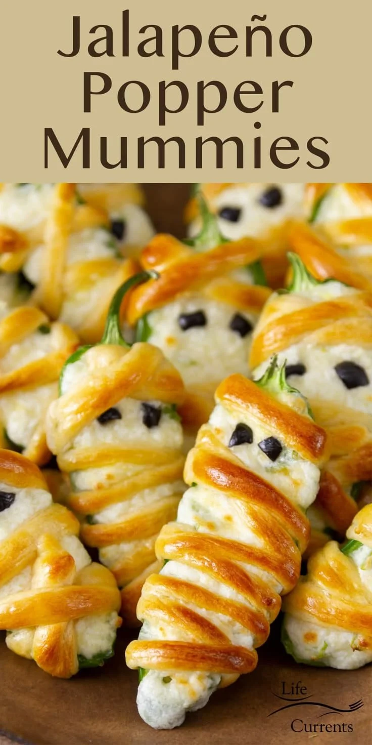 Jalapeno popper mummies Halloween appetizers on a festive platter