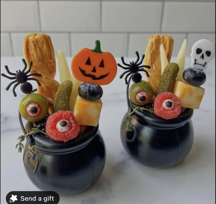 Mini cauldron snack cups filled with Halloween treats