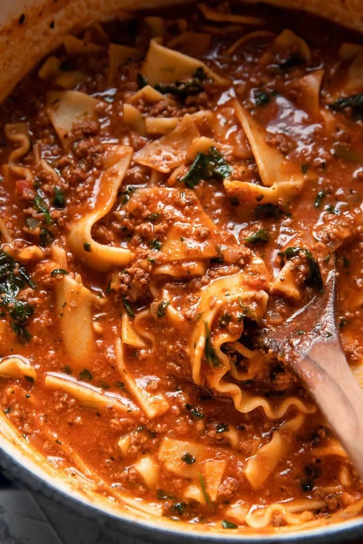 Delicious One Pot Lasagna Soup served in a bowl with cheese and herbs on top.