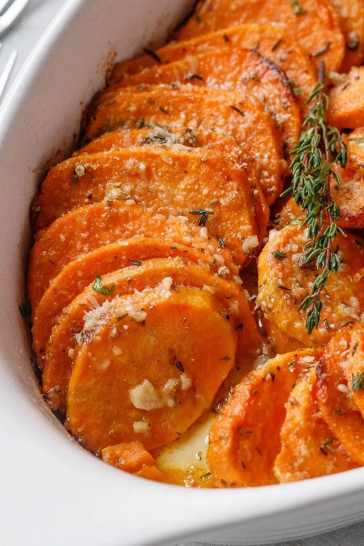 Roasted sweet potato garnished with garlic and parmesan on a plate
