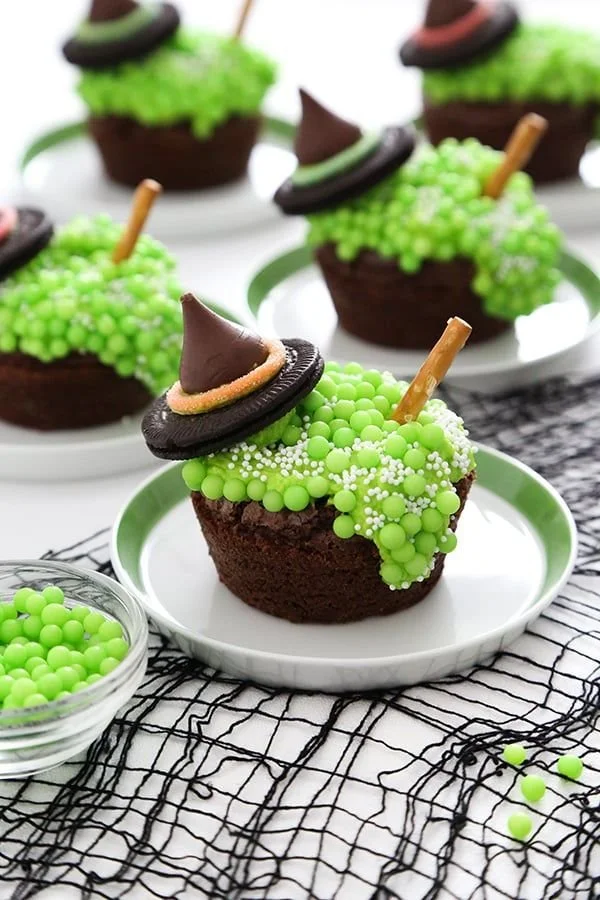 Decorative spooky Halloween treats like ghostly cupcakes and pumpkin cookies.