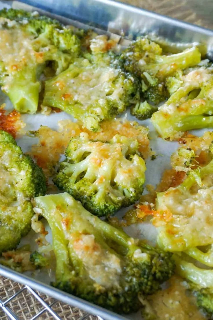 Smashed Brokkoli topped with Parmesan cheese, a healthy and flavorful dish.