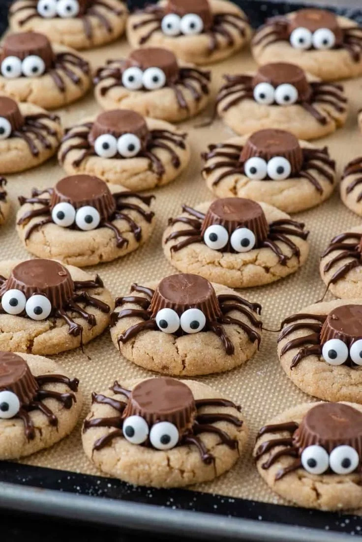 Soft and chewy peanut butter cookies decorated as spiders for Halloween.