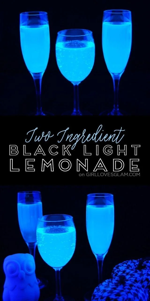 A glowing spooky black light lemonade in a glass with ice and garnishes.