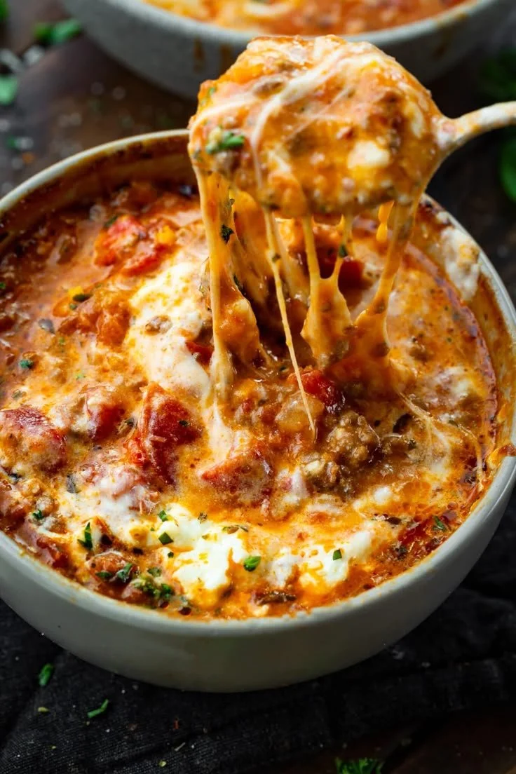 Delicious bowl of lasagna soup topped with cheese and herbs.